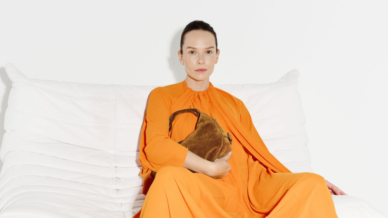 OFFICINE CREATIVE - Women's brown suede bag on a white couch